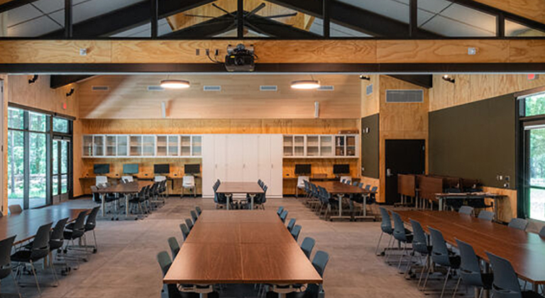 Large, versatile meeting room with ample seating and modern lighting