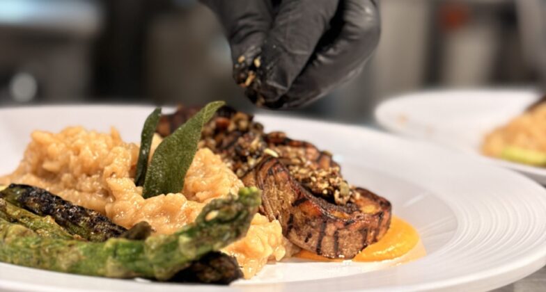 Plated pork dish by EHN culinary team.