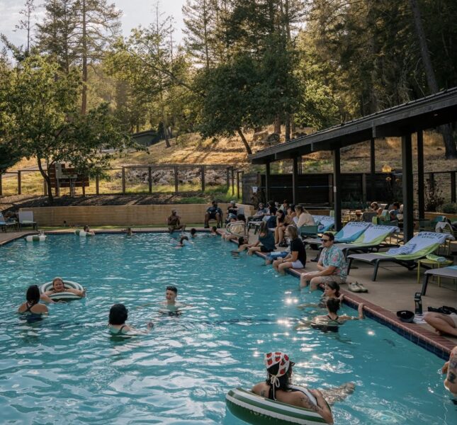 People swimming and hanging out at the pool.